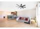 Cozy living room with a ceiling fan, comfortable sofa, and access to the backyard at 3896 Grassland Dr, Orlando, FL 32824