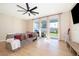 Bright and airy living room with large windows, ceiling fan, and sliding glass doors to the patio at 3896 Grassland Dr, Orlando, FL 32824