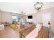 Open-concept living and dining area with a ceiling fan, large windows, and modern decor at 3896 Grassland Dr, Orlando, FL 32824