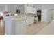 White kitchen features ample counter space and wood flooring at 411 Ridge View Dr, Davenport, FL 33837