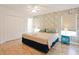 Main bedroom with king bed, walk-in closet, and wood floors at 4577 Alberto Cir, Kissimmee, FL 34746
