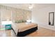 Spacious bedroom with king bed, wood floors, and accent wall at 4577 Alberto Cir, Kissimmee, FL 34746