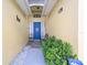 Inviting entryway with a blue door and well-manicured landscaping at 4634 Eagle Peak Dr, Kissimmee, FL 34746