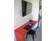 Small workspace with a red desk and black chair at 5245 W Irlo Bronson Memorial Hwy # 115, Kissimmee, FL 34746