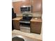 Kitchen with stainless steel appliances, wood cabinets, and light countertops at 5259 Images Cir # 206, Kissimmee, FL 34746