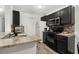 Small kitchen with dark cabinets and granite countertops at 5267 Images Cir # 308, Kissimmee, FL 34746