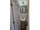 Small bathroom with gray vanity, white tile, and a teal framed mirror at 721 Langston Ave, Haines City, FL 33844