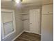 Bright bedroom featuring wood-look floors and ample closet space at 721 Langston Ave, Haines City, FL 33844