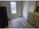 Well-lit bedroom with wood-look floors and a window at 721 Langston Ave, Haines City, FL 33844