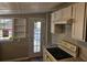 Kitchen boasts white cabinets, stove, and exterior access at 721 Langston Ave, Haines City, FL 33844