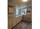 Kitchen with white cabinets, sink, and wood-look floors at 721 Langston Ave, Haines City, FL 33844