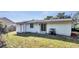 Rear view of house showing exterior and landscaping at 857 Glasgow Ave, Deltona, FL 32738