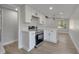 Modern kitchen featuring white shaker cabinets, stainless steel appliances, and quartz countertops at 857 Glasgow Ave, Deltona, FL 32738