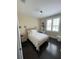 Bright bedroom with a queen-size bed, dark hardwood floors, and ample natural light at 8919 Lakeshore Pointe Dr, Winter Garden, FL 34787