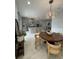 Bright dining area with a large wooden table and modern chairs at 8919 Lakeshore Pointe Dr, Winter Garden, FL 34787