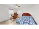 Bedroom with wood-look flooring, ceiling fan, and simple furnishings at 1006 Plantation Dr # F12, Kissimmee, FL 34741