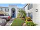 Building exterior with arched entryway, stairs, and tropical landscaping at 1006 Plantation Dr # F12, Kissimmee, FL 34741