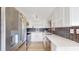 Modern kitchen with white cabinets, updated appliances, and decorative backsplash at 1006 Plantation Dr # F12, Kissimmee, FL 34741