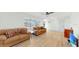 Bright living area featuring wood-look flooring, comfortable seating, and a TV at 1006 Plantation Dr # F12, Kissimmee, FL 34741