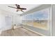 Bright sunroom with large windows, wood-look flooring, and ceiling fan at 1006 Plantation Dr # F12, Kissimmee, FL 34741