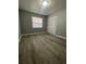 Well-lit bedroom, wood-look floors, and double-door closet at 1307 Se 38Th Ave, Ocala, FL 34471