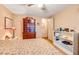 Second bedroom features floral bedding, a tall wood dresser, and ceiling fan at 1915 Stacey Dr, Mount Dora, FL 32757