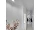 A light and airy hallway with floral wall art leading to other rooms at 2430 Berkshire Ct, Kissimmee, FL 34746