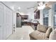 Modern kitchen with dark wood cabinets, stainless steel appliances, and a breakfast bar at 2430 Berkshire Ct, Kissimmee, FL 34746