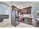 Modern kitchen with dark brown cabinets, white countertops, and stainless steel appliances at 2430 Berkshire Ct, Kissimmee, FL 34746