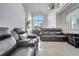 Relaxing living room with a large sectional sofa and view of back yard at 2430 Berkshire Ct, Kissimmee, FL 34746