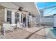 Relaxing covered patio with multiple ceiling fans and seating area near the pool at 2430 Berkshire Ct, Kissimmee, FL 34746