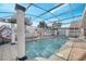 Inviting screened-in pool with a covered patio and elegant columns at 2430 Berkshire Ct, Kissimmee, FL 34746