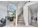 Elegant staircase with light wood treads and a large window above at 2430 Berkshire Ct, Kissimmee, FL 34746