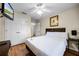 Bedroom featuring wooden flooring, ceiling fan, and an inviting bed at 3145 Yellow Lantana Ln, Kissimmee, FL 34747