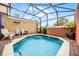 Private pool with a screened enclosure and seating area at 3145 Yellow Lantana Ln, Kissimmee, FL 34747