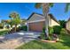 Single-story home with attached garage and landscaped yard at 336 Alicante Ct, Davenport, FL 33837