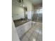 Clean bathroom boasts a granite countertop, shower/tub combo, and tile floors at 3429 Wilderness Trl, Kissimmee, FL 34746