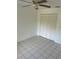 Bedroom featuring white closet doors, ceiling fan, and tiled floors at 3429 Wilderness Trl, Kissimmee, FL 34746