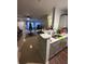 Open-concept living area with a Christmas tree, tile flooring, and a view into the kitchen at 4320 S Kirkman Rd # 1513, Orlando, FL 32811