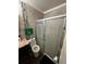Bathroom featuring a vanity, toilet, and a glass-enclosed shower at 4368 S Kirkman Rd # 201, Orlando, FL 32811