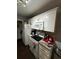 Well-equipped kitchen with white cabinetry, granite counters, and modern appliances at 4368 S Kirkman Rd # 201, Orlando, FL 32811