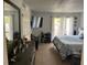View of a bedroom with a bed, desk, TV, and balcony access at 508 Orange Dr # 20, Altamonte Springs, FL 32701