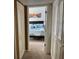 Hallway leading to a bedroom with a teal and white bedspread and Venice-themed wall art at 508 Orange Dr # 20, Altamonte Springs, FL 32701