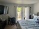 Bedroom with a large bed, TV, and access to a balcony at 508 Orange Dr # 20, Altamonte Springs, FL 32701