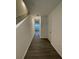 Inviting entryway with dark wood-look flooring and a view down the hallway at 520 Madison Dr, Davenport, FL 33837