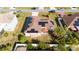 Aerial perspective of the property within its fenced backyard, showcasing landscaping and solar panels at 622 Parakeet Ct, Kissimmee, FL 34759