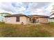 Spacious backyard with a patio, dining set, and solar panels on the roof at 622 Parakeet Ct, Kissimmee, FL 34759