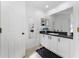 Modern bathroom with white vanity, dark countertop, and black fixtures at 622 Parakeet Ct, Kissimmee, FL 34759