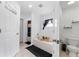 Bright bathroom with white fixtures, a bathtub, and patterned floor mat at 622 Parakeet Ct, Kissimmee, FL 34759