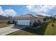 Side view of the house, highlighting the solar panels on the roof at 622 Parakeet Ct, Kissimmee, FL 34759
